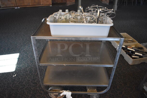 Stainless Steel Commercial 3 Tier Cart w/ Push Handle, Glass Liquid Condiment Holders and Metal Stands on Commercial Casters. 27.5x18x32.5. (back dining room)