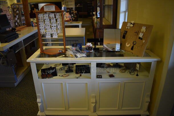 White Wooden Counter w/ Contents Including Jewelry. BUYER MUST REMOVE. 64x24x39. (yellow clothing store)