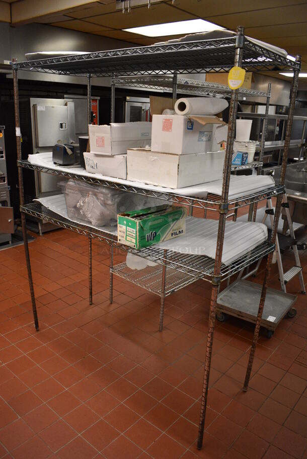Chrome Finish 3 Tier Shelving Unit w/ Contents Including Edlund Knife Sharpener and Various Paper Products. BUYER MUST DISMANTLE. PCI CANNOT DISMANTLE FOR SHIPPING. PLEASE CONSIDER FREIGHT CHARGES. 60x24x74. (kitchen) - Image 1 of 7