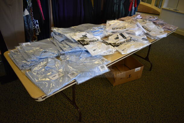 Folding Table and Contents Including Shirts. 96x30x29. (yellow clothing store)