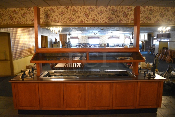 Portable Buffet Station w/ 4 Plate Return Chutes, Sneeze Guard and Wooden Exterior on Commercial Casters. 135x42x98. Unit Was In Working Condition When Restaurant Closed. BUYER MUST REMOVE. (buffet)