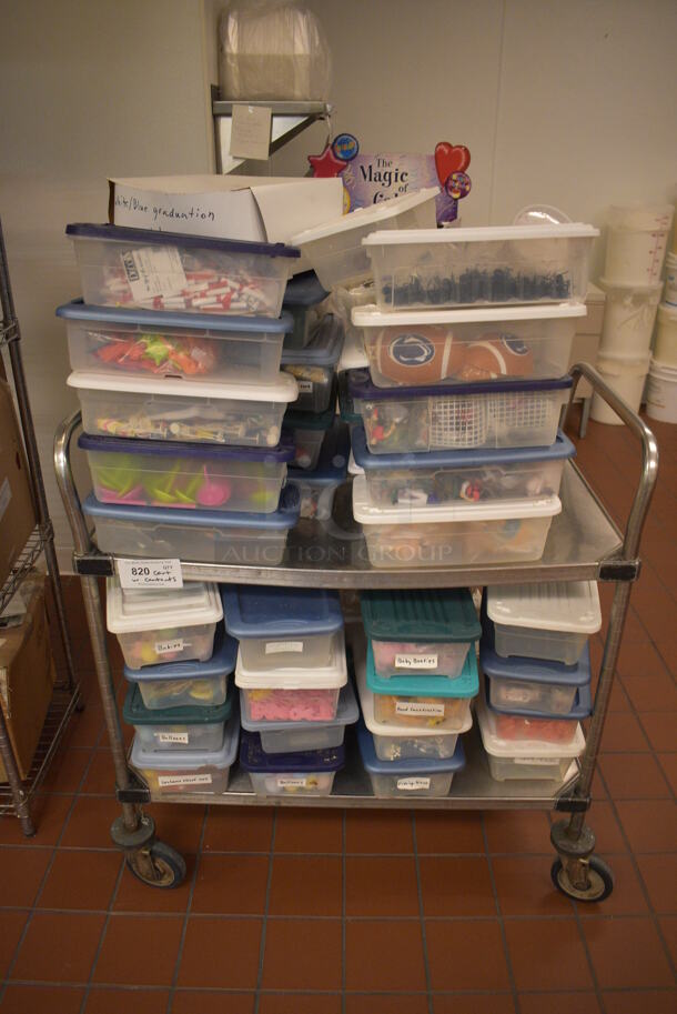 Stainless Steel Commercial 2 Tier Cart w/ Push Handles and Various Cake / Cupcake Toppers Including Footballs and Rings on Commercial Casters. 36x21x39.5. (icing kitchen) - Image 1 of 6