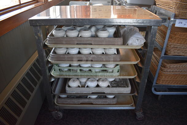 Stainless Steel Commercial Pan Rack w/ 5 Dish Caddies and Approximately 60 White Ceramic Pitchers on Commercial Casters. 30.5x22x34. Includes 4x3.5x3.5. (back dining room)