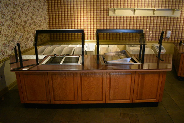Portable Buffet Station w/ 2 Double Well Steam Tables, 2 Sneeze Guards and Wooden Exterior on Commercial Casters. BUYER MUST REMOVE. 158x42x59. Unit Was In Working Condition When Restaurant Closed. (buffet)