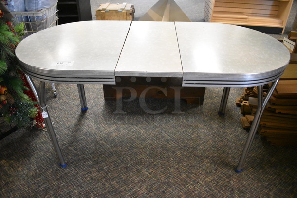 Gray Oval Table. 60x30x30. (garden center)