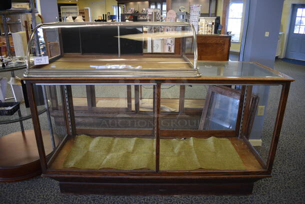 Glass Merchandising Case w/ Small Top Case. BUYER MUST REMOVE. 48x27x13, 73x26x42. (yellow clothing store)