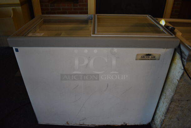 Arctic Air Model ST09G2 Metal Commercial Freezer w/ 2 Sliding Lids on Commercial Casters. 115 Volts, 1 Phase. 42x22.5x37. Unit Was In Working Condition When Restaurant Closed. (main dining room)