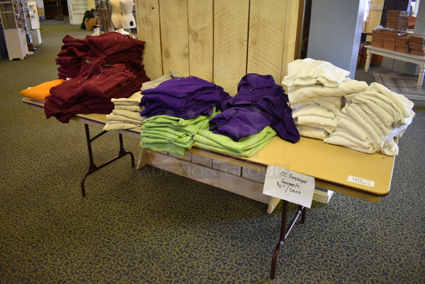 Folding Table w/ Shirts. 96x30x29. (yellow clothing store)