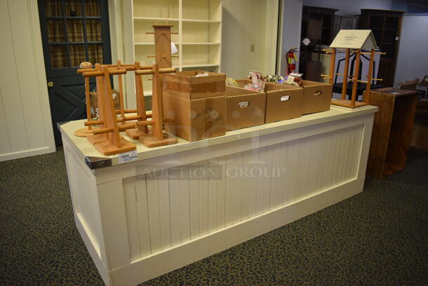 White Wooden Counter w/ Various Wooden Stands and Tea Leaves. BUYER MUST REMOVE. 96x36x32. (yellow clothing store)