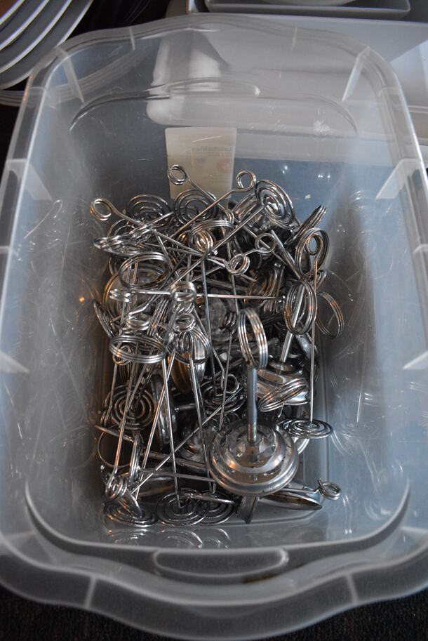ALL ONE MONEY! Lot of Various Metal Countertop Table Number Holders in Clear Bin! Includes 2x2x7. 16.5x11x11. (main dining room) - Image 2 of 3