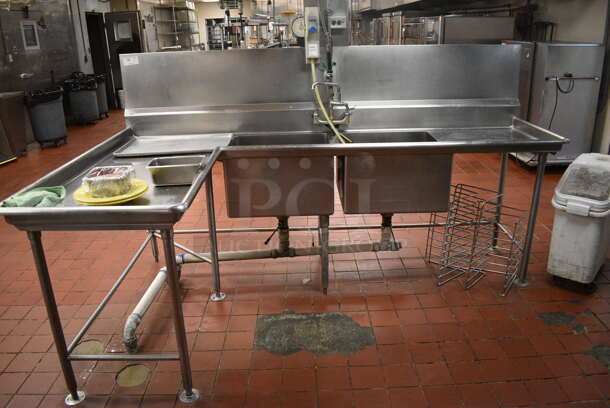 Stainless Steel Commercial 2 Bay Sink w/ Dual Drainboards, Faucets, Handles and Back Splash. Does Not Include Contents. BUYER MUST REMOVE. 105x64x56. Bays 24x24x14. Drainboards 62x30x38, 24x26x2. (kitchen)