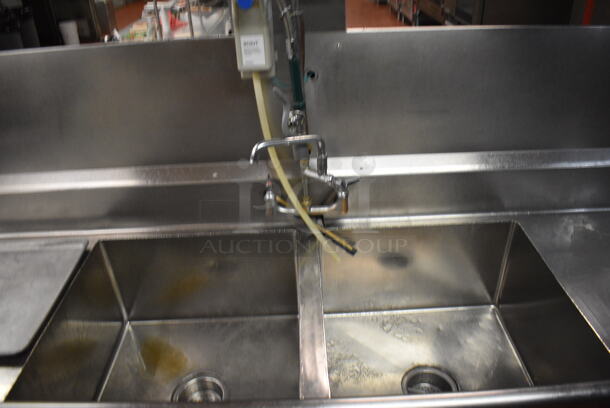 Stainless Steel Commercial 2 Bay Sink w/ Dual Drainboards, Faucets, Handles and Back Splash. Does Not Include Contents. BUYER MUST REMOVE. 105x64x56. Bays 24x24x14. Drainboards 62x30x38, 24x26x2. (kitchen) - Image 3 of 6