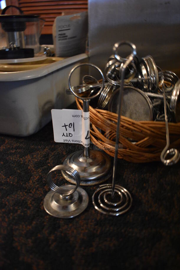 ALL ONE MONEY! Lot of Various Metal countertop Table Number Holders in Basket! Includes 3x3x6. (main dining room) - Image 2 of 3