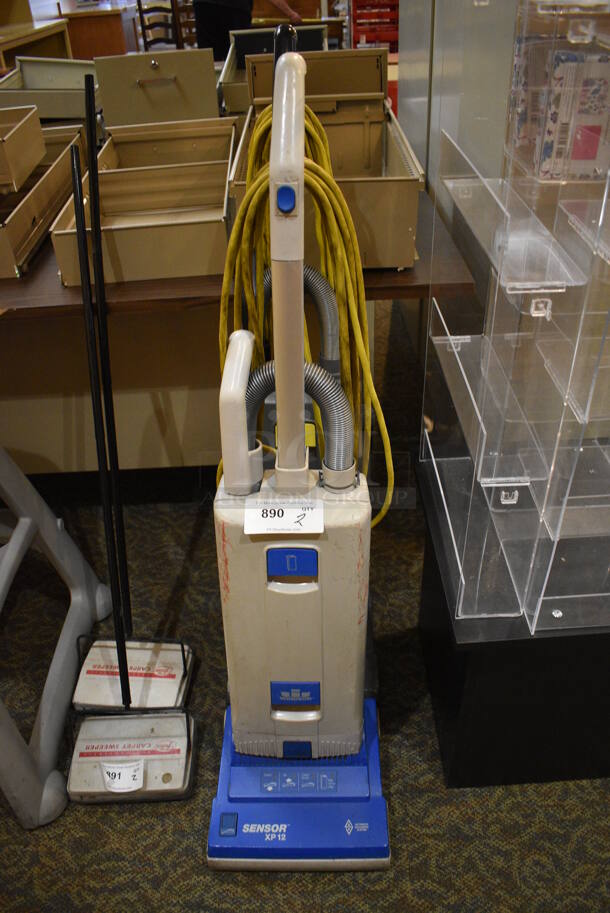 2 Windsor Sensor Commercial Vacuum Cleaners. 12x12x47. 2 Times Your Bid! Unit Was In Working Condition When Restaurant Closed. (gift shop) - Image 1 of 3