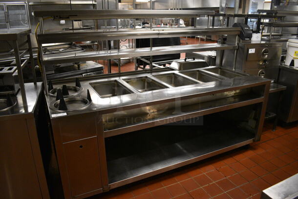 Stainless Steel Commercial Electric Powered 5 Bay Steam Table w/ 2 Plate Return Chutes, Double Over Shelf, Warming Strip and Under Shelf on Commercial Casters. 88.5x45x63. Unit Was In Working Condition When Restaurant Closed. (kitchen)