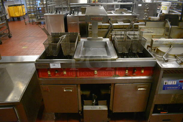 Vulcan Model SPERI-SESFABZ Stainless Steel Commercial Floor Style Electric Powered 2 Bay Fryer w/ Center Dumping Warming Station, Warming Strip and 4 Metal Fry Baskets. 208 Volts, 3 Phase. 46.5x28.5x53. Unit Was In Working Condition When Restaurant Closed. (kitchen)