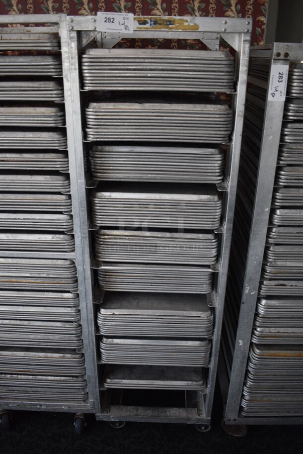 Metal Commercial Pan Transport Rack w/ 81 Metal Full Size Baking Pans on Commercial Casters. 20.5x26x68.5. 18x26x1. (sunroom dining room) - Image 1 of 5