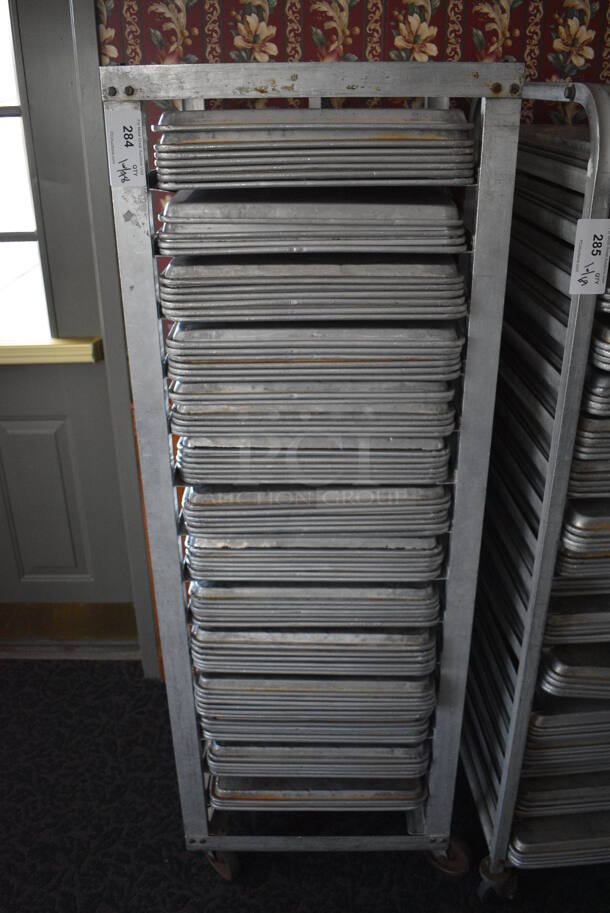 Metal Commercial Pan Transport Rack w/ 78 Metal Full Size Baking Pans on Commercial Casters. 22.5x26.5x66. 18x26x1. (sunroom dining room) - Image 1 of 5