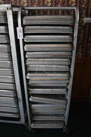 Metal Commercial Pan Transport Rack w/ 69 Metal Full Size Baking Pans on Commercial Casters. 20.5x28x65. 18x26x1. (sunroom dining room)
