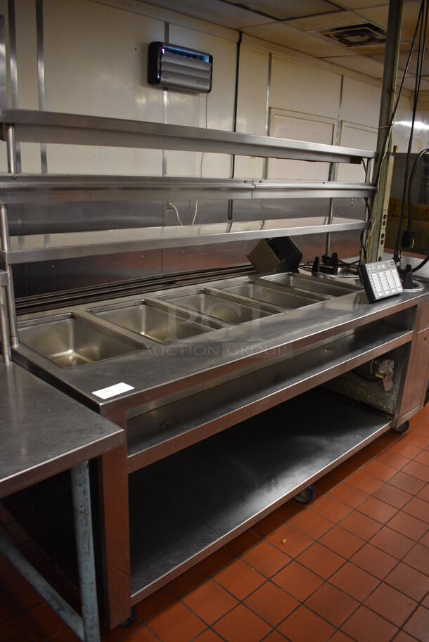 Stainless Steel Commercial 5 Well Steam Table w/ 2 Plate Return Chutes, Tray Slide, 2 Over Shelves and Under Shelf on Commercial Casters. 88.5x45x64.5. Unit Was In Working Condition When Restaurant Closed. (kitchen)