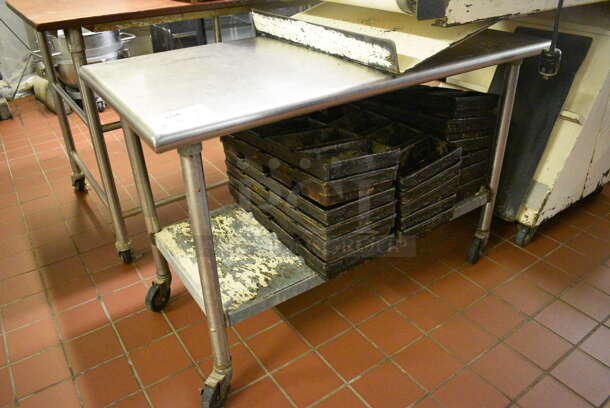 Stainless Steel Commercial Table w/ Metal Under Shelf on Commercial Casters. Does Not Include Contents. 48x24x32. (bakery kitchen)