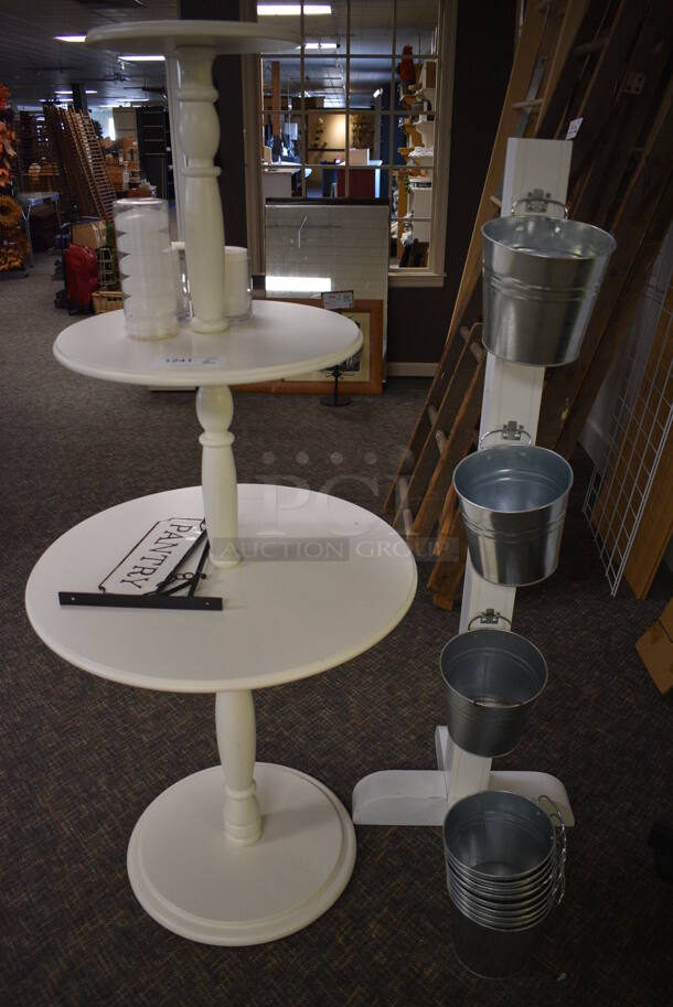 2 Various Stands; White Wooden 2 Tier Round Stand and Stand w/ Metal Buckets. 27x27x61, 19x19x57. 2 Times Your Bid! (garden center)