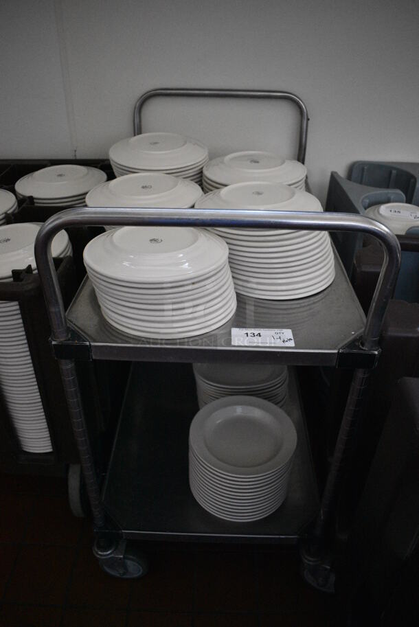 Stainless Steel Commercial 2 Tier Cart w/ Push Handles and Various Ceramic Plates on Commercial Casters. 37x21x40. Includes 9.75x9.75x1. (kitchen hallway) - Image 1 of 5