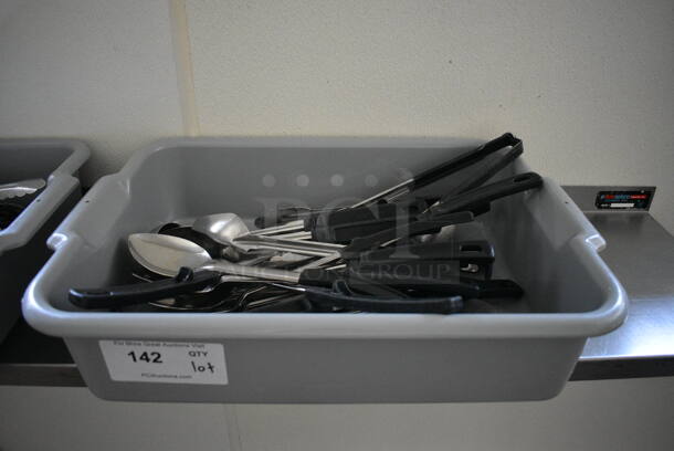 ALL ONE MONEY! Lot of Various Utensils Including Serving Spoons in Gray Bus Bin! 21x15x5. (kitchen hallway)