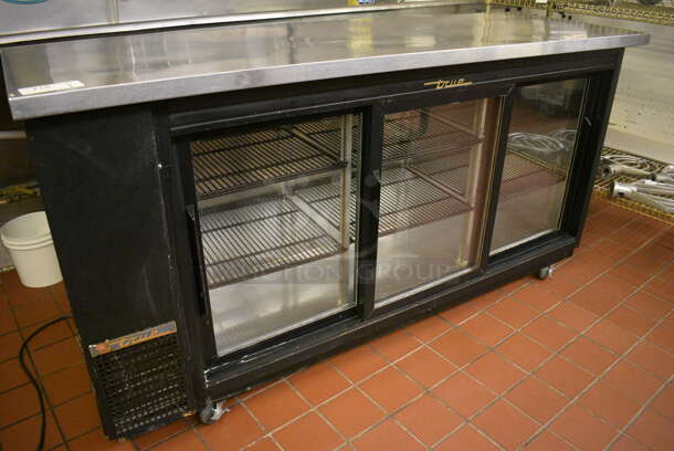 2012 True Model TBB-24-72G-SD Stainless Steel Commercial 3 Door Back Bar Cooler Merchandiser on Commercial Casters. 115 Volts, 1 Phase. 73x24.5x39.5. Unit Was In Working Condition When Restaurant Closed. (bakery kitchen) - Image 1 of 6
