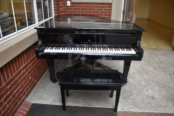Young Chang Black Floor Style Piano on Commercial Casters w/ Bench. BUYER MUST REMOVE: Give Yourself Ample Time To Remove This Item on Pick Up Day. 59x70x40.5, 30x14x18.5. (atrium)