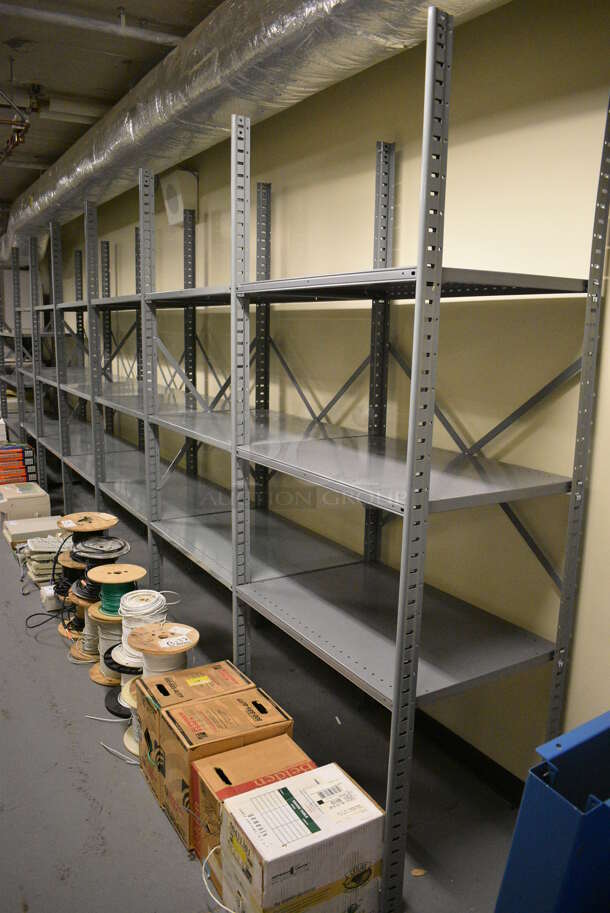 Gray Metal Shelving Unit. BUYER MUST REMOVE: Give Yourself Ample Time To Remove This Item on Pick Up Day. 415x24x87. (south basement 012)