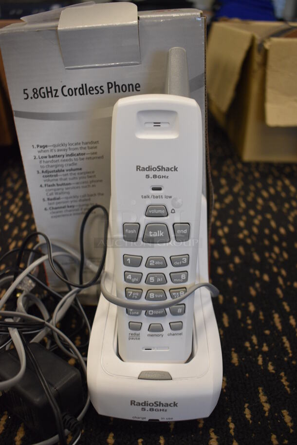 IN ORIGINAL BOX! RadioShack Phone in Cradle. 3.5x4x8.5. (room 204)