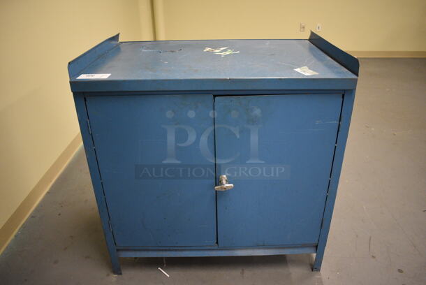 Blue Metal 2 Door Cabinet. 36x25x37. (south basement 017)