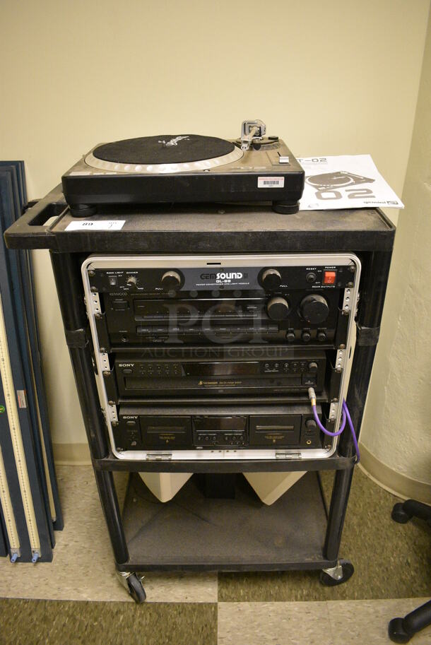 Black AV Cart w/ Gemini TT02 Full Manual Direct Drive Turntable Record Player, GEM Sound GL-99 Power Conditioner and Light Module, Sony Disc Player and 2 JBL Speakers on Commercial Casters. 27x18x45 - Image 1 of 12