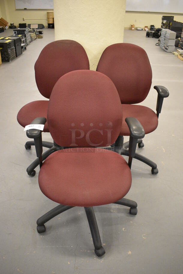 3 Maroon Office Chairs w/ Arm Rests on Casters. 25x22x37. 3 Times Your Bid! (south basement 019)