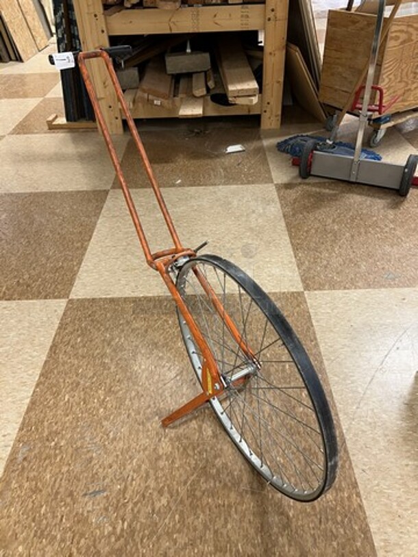 Orange Metal Measuring Wheel. 12x39x34. (room 122)