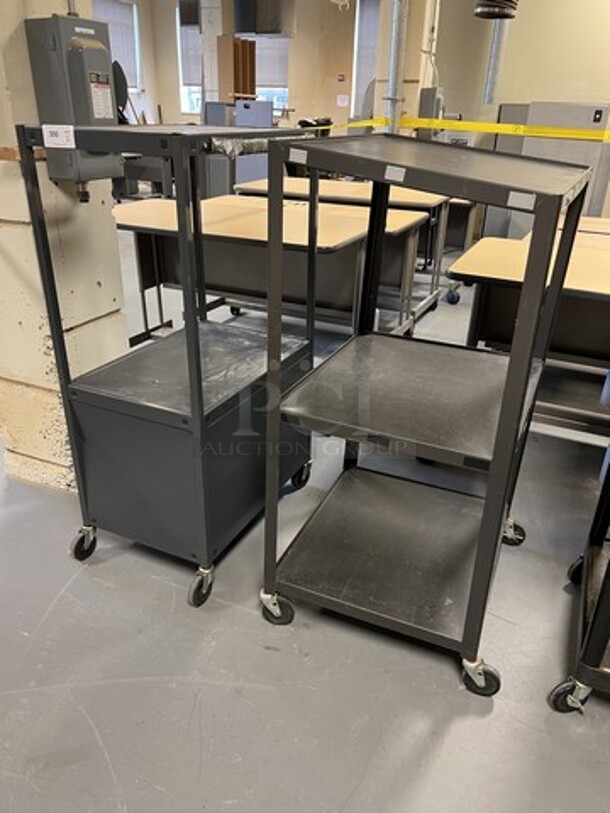 2 Black Metal 2 Tier AV Cart on Commercial Casters. 25x29x54, 22x30x54. 2 Times Your Bid! (room 130)