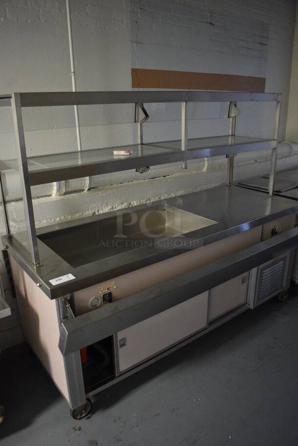 Servolift Eastern Model 502-3R Metal Commercial Portable Buffet Station w/ 2 Over Shelves and Tray Slide on Commercial Casters. BUYER MUST REMOVE. 120/208 Volts, 1 Phase. 76.5x44x64. (Clearview Elementary - Lower Level)