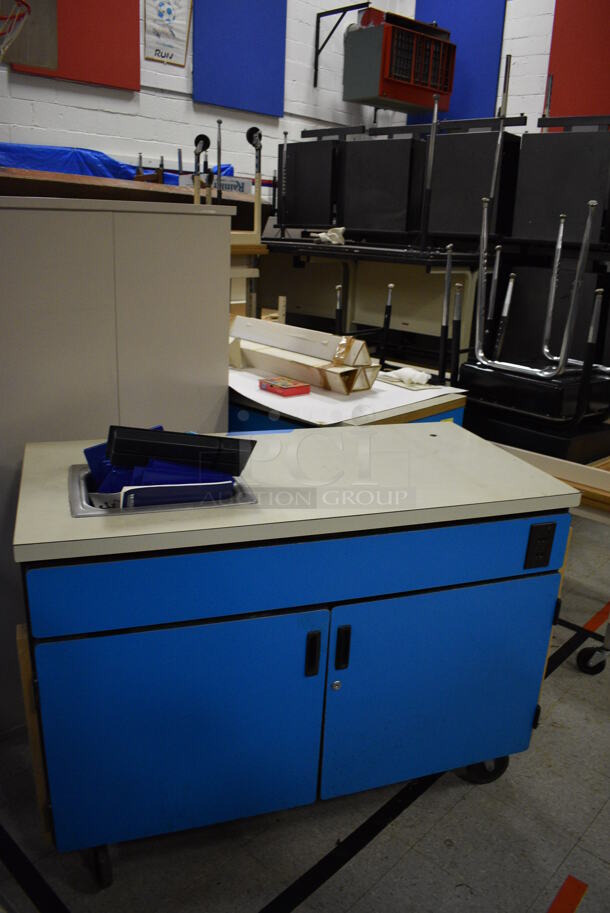 ALL ONE MONEY! Lot of Various Items Including Tables, Cabinet, Desks, Blue Portable Cabinets. Does Not Include Portable Record Players. BUYER MUST REMOVE. Includes 33.5x25.5x39.5. (Clearview Elementary - Gym) - Image 5 of 6