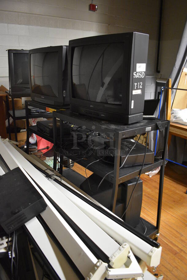 ALL ONE MONEY! Lot of Various Items Including 58 Projector Screens, Televisions, AV Carts. Does Not Include Fire Extinguisher. BUYER MUST REMOVE. Includes 32.5x22x71. (Clearview Elementary - Stage) - Image 4 of 6
