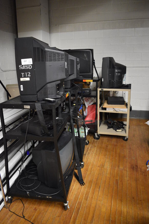 ALL ONE MONEY! Lot of Various Items Including 58 Projector Screens, Televisions, AV Carts. Does Not Include Fire Extinguisher. BUYER MUST REMOVE. Includes 32.5x22x71. (Clearview Elementary - Stage) - Image 5 of 6