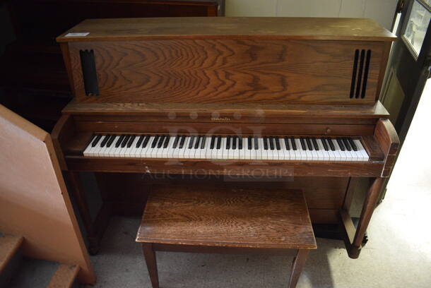 Baldwin Wooden Piano w/ Bench. BUYER MUST REMOVE. 51x25x46.5. (Clearview Elementary - Hallway Behind Gym)
