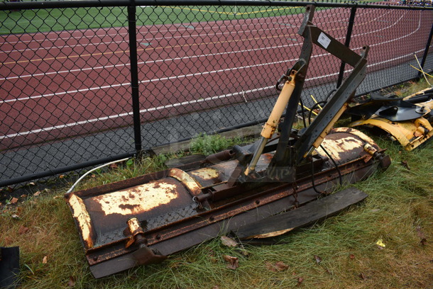 Yellow Metal Front Hitch Snow Plow Attachment. BUYER MUST REMOVE. 90x46.5x25. (stadium)