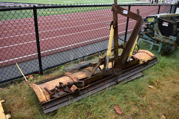 Yellow Metal Front Hitch Snow Plow Attachment. BUYER MUST REMOVE. 102x52.5x23.5. (stadium)