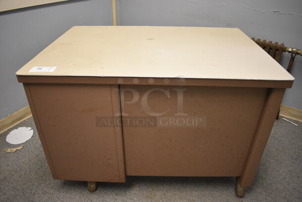 Brown Metal Desk w/ 2 Drawers. BUYER MUST REMOVE. 43x30x30. (Clearview Elementary - Room Between 6 and 7)