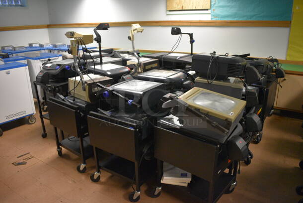 21 Black Metal AV Carts w/ Approximately 30 Overhead Projectors. BUYER MUST REMOVE. Includes 18x24x39. 21 Times Your Bid! (Clearview Elementary - Lower Level)