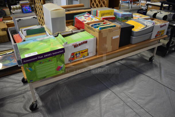 Wood Pattern Table on Commercial Casters and Contents Including Books. 90.5x30.5x22. (Middle School Gym) 
