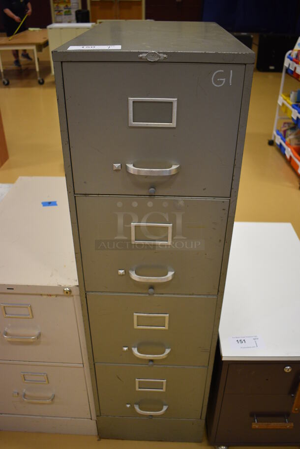 Gray Metal 4 Drawer Filing Cabinet. 15x29x52. (Chipperfield Elementary Gym)