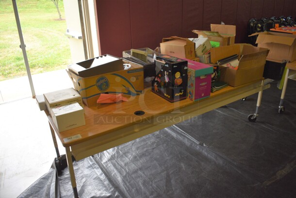 Wood Pattern Tabletops on Commercial Casters w/ Contents Including Doilies and Books. 90.5x30.5x26. (Middle School Gym)