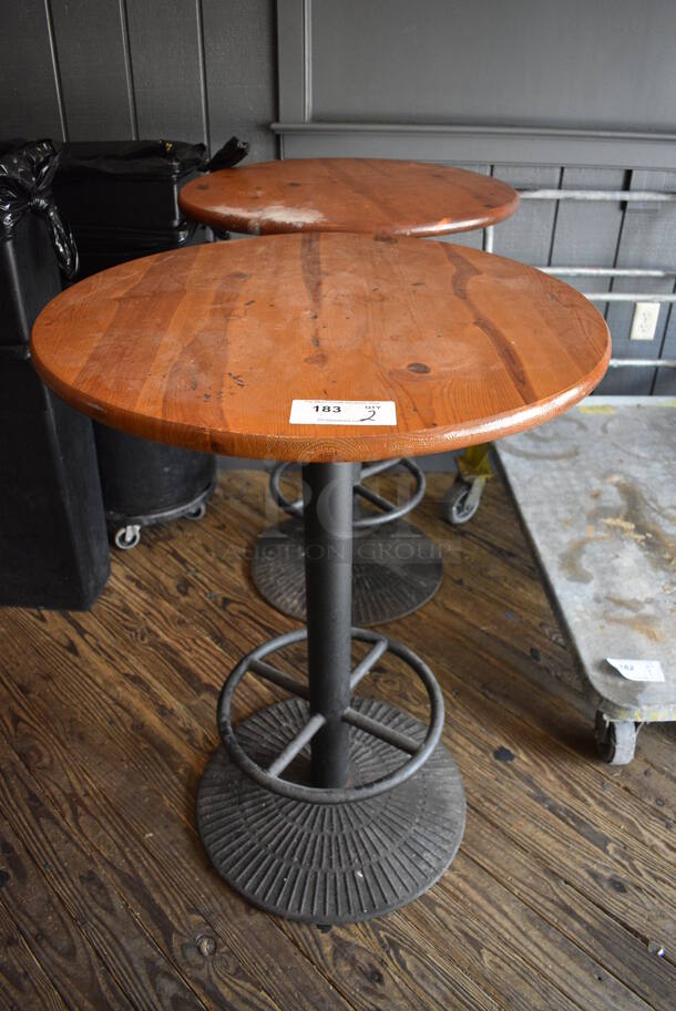 2 Wooden Round Bar Height Tables on Metal Table Base. 29.5x29.5x42. 2 Times Your Bid! (vestibule)